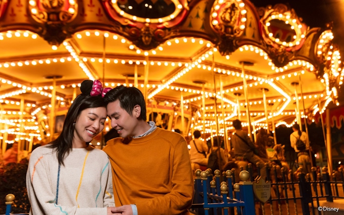 Couple enjoying Cinderella carousel at Disneyland Hong Kong.