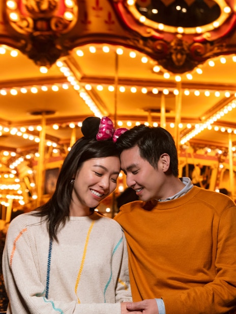 Couple enjoying Cinderella carousel at Disneyland Hong Kong.