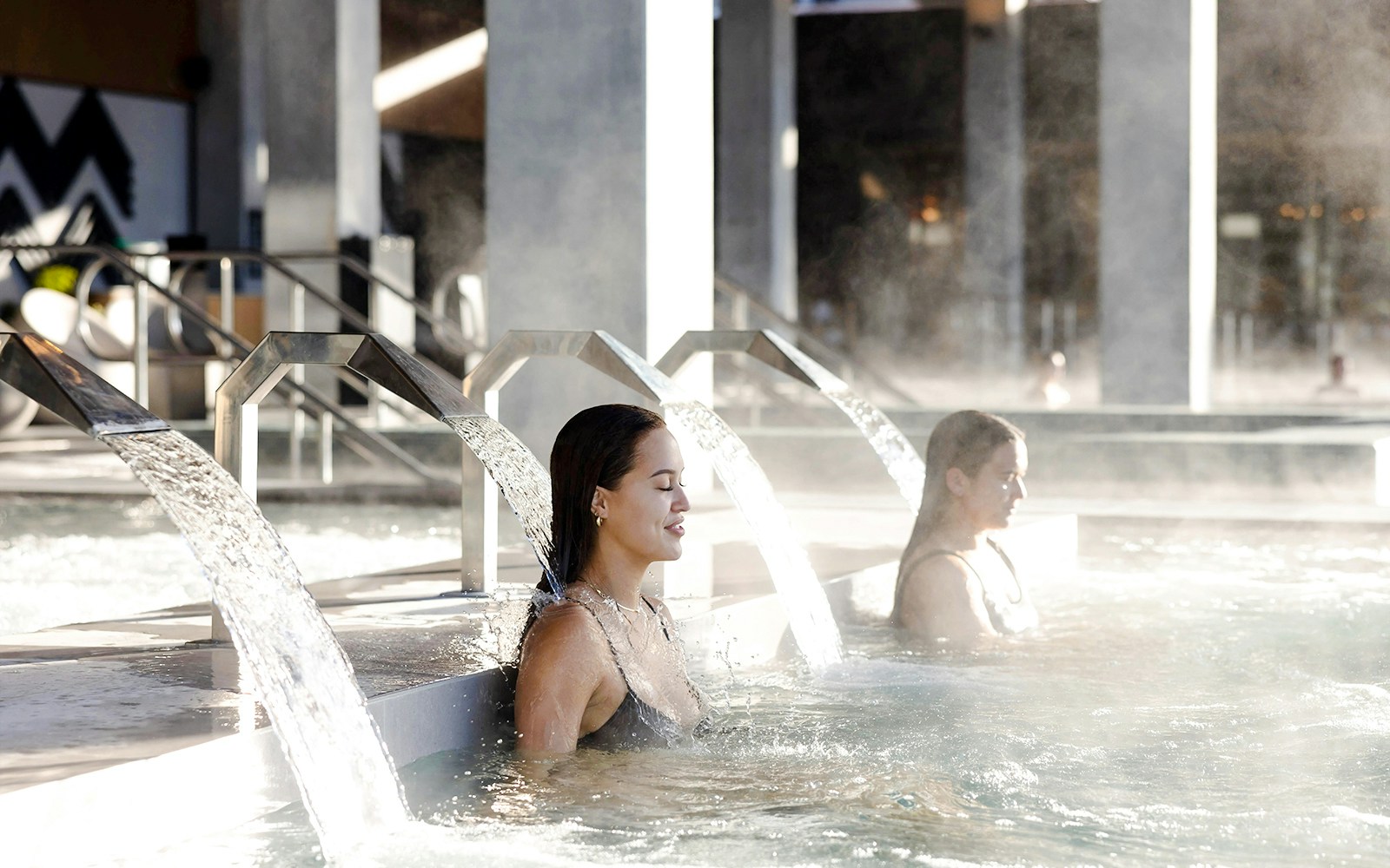 Women relaxing under water jets at Wai Ariki Hot Springs & Spa.