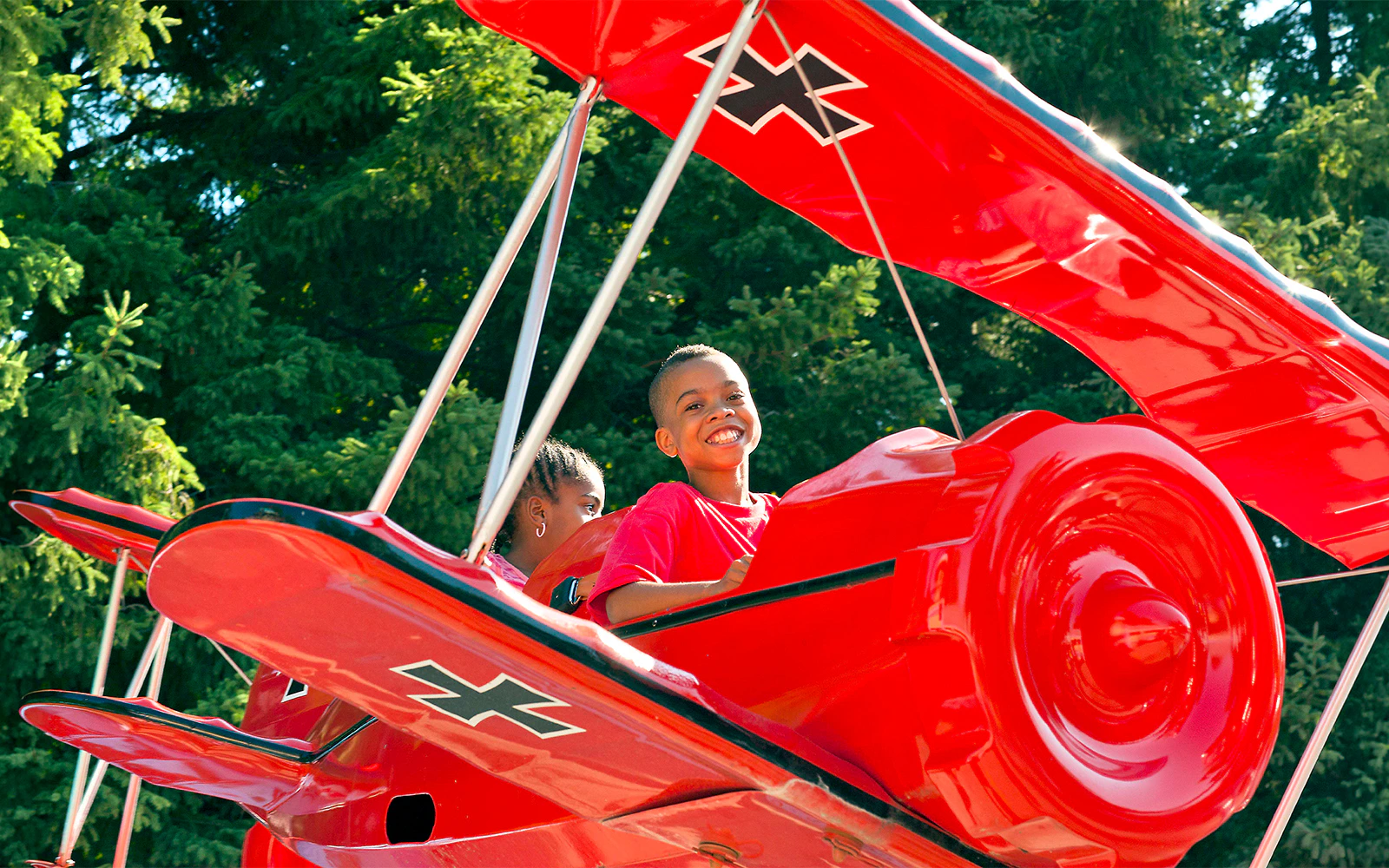 Children enjoying the SNOOPY® vs Red Baron ride at Canada's Wonderland.