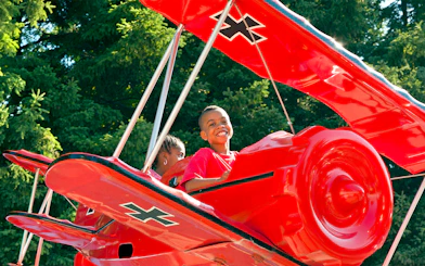 Children enjoying the SNOOPY® vs Red Baron ride at Canada's Wonderland.