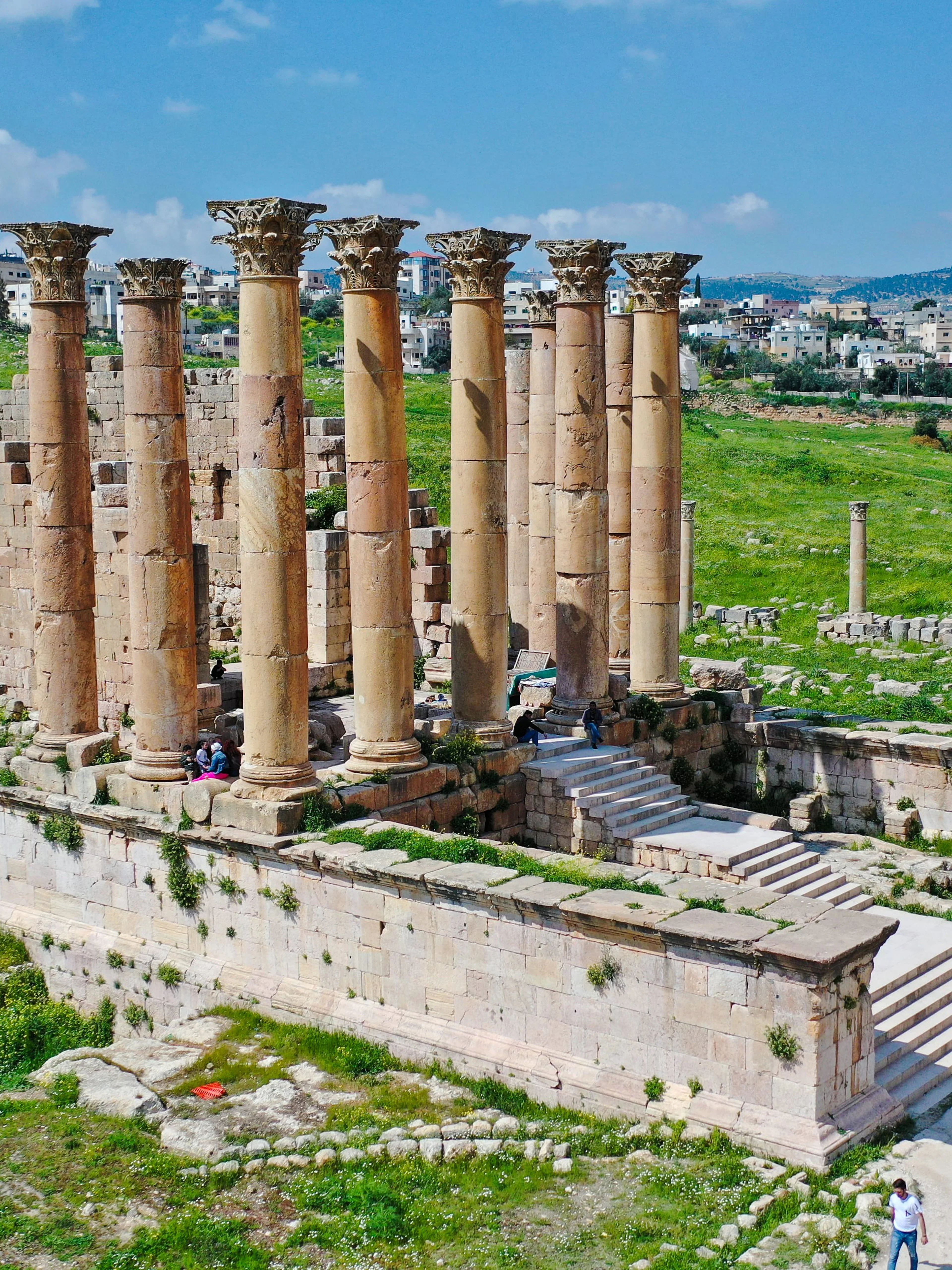 Temple of Artemis ruins in Jerash, Jordan, with ancient columns and surrounding landscape.