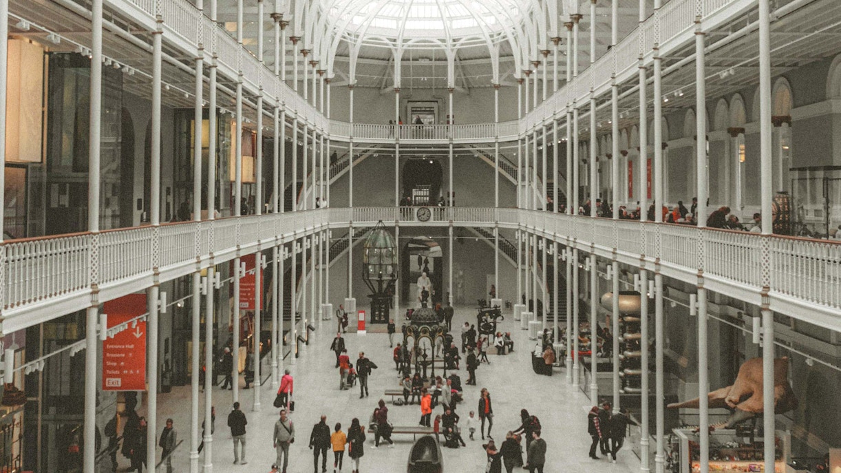 Visitors exploring the grand hall of the National Museum of Scotland.