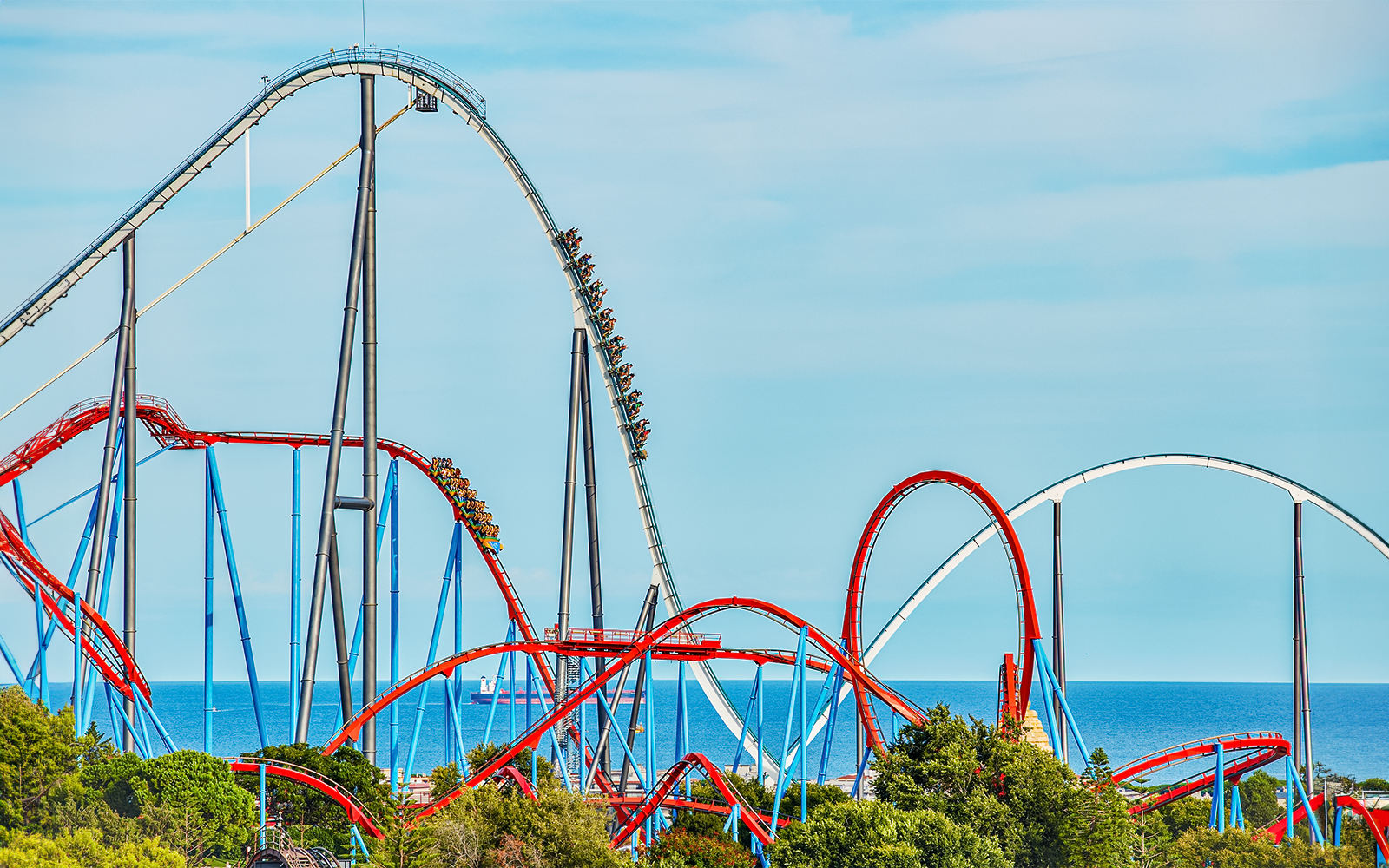 Roller coaster Dragon Khan at PortAventura with loops and sea view.