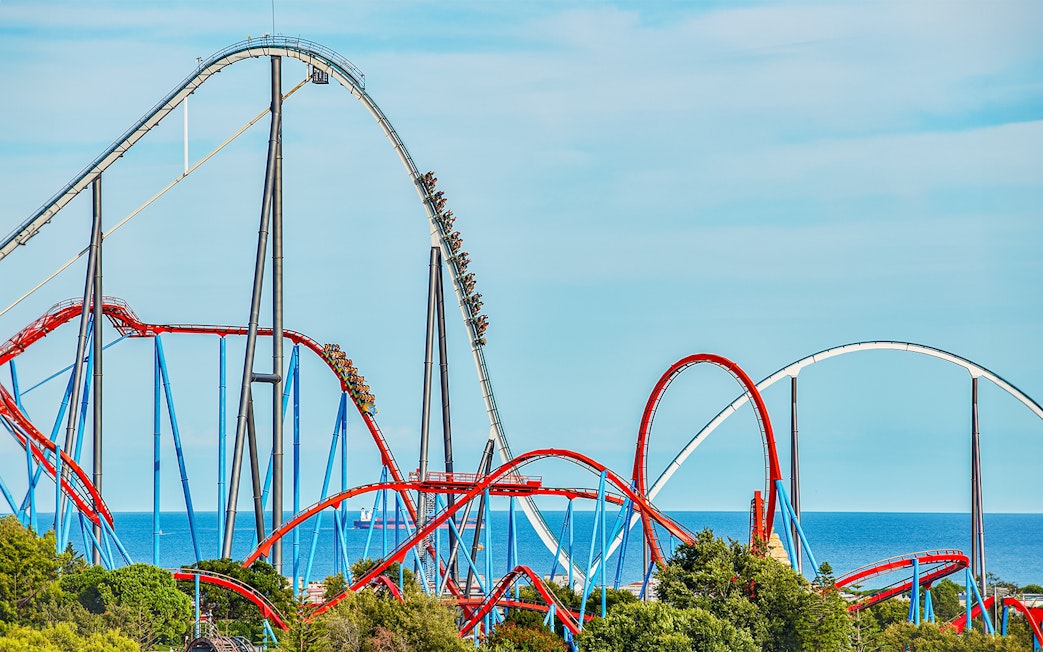 Roller coaster Dragon Khan at PortAventura with loops and sea view.