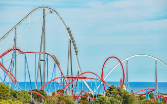 Roller coaster Dragon Khan at PortAventura with loops and sea view.