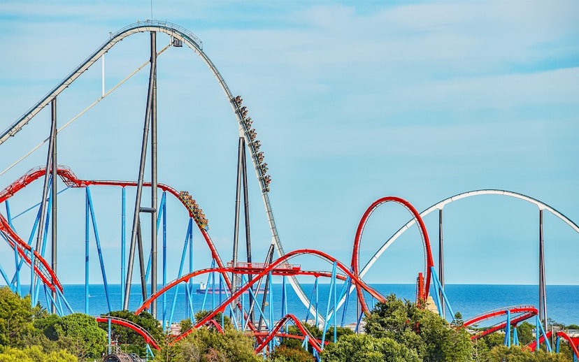 Roller coaster Dragon Khan at PortAventura with loops and sea view.