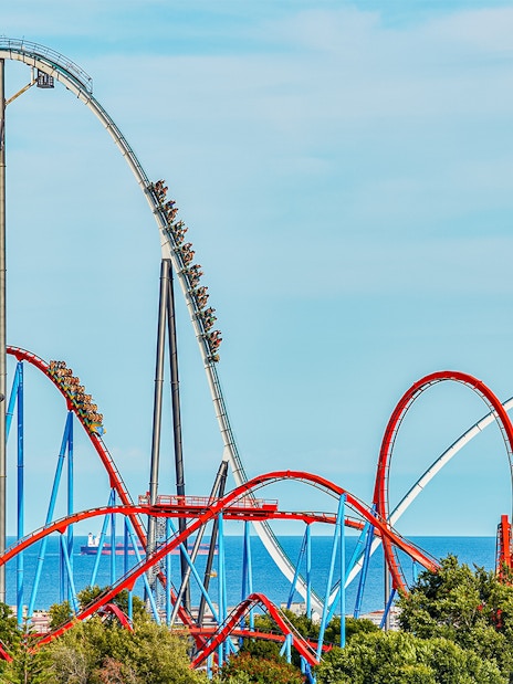 Roller coaster Dragon Khan at PortAventura with loops and sea view.