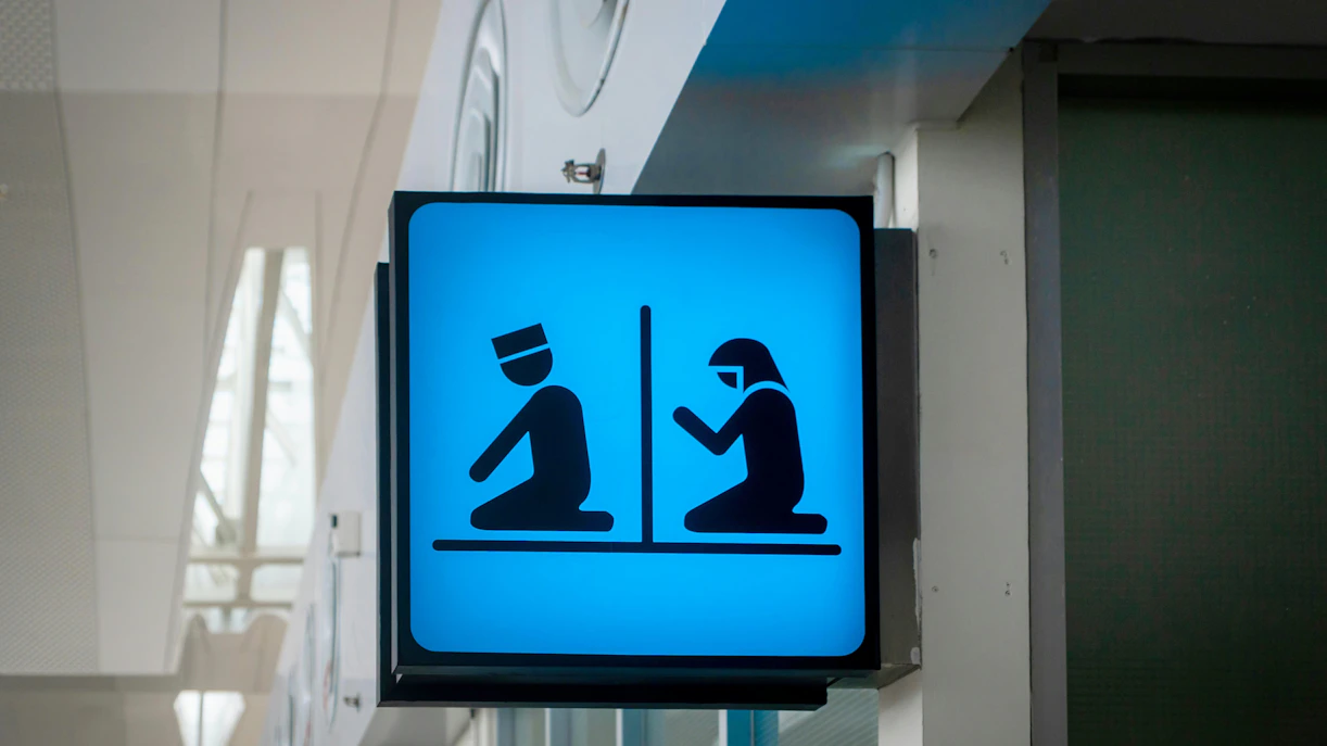 Prayer room sign with male and female symbols in an airport.