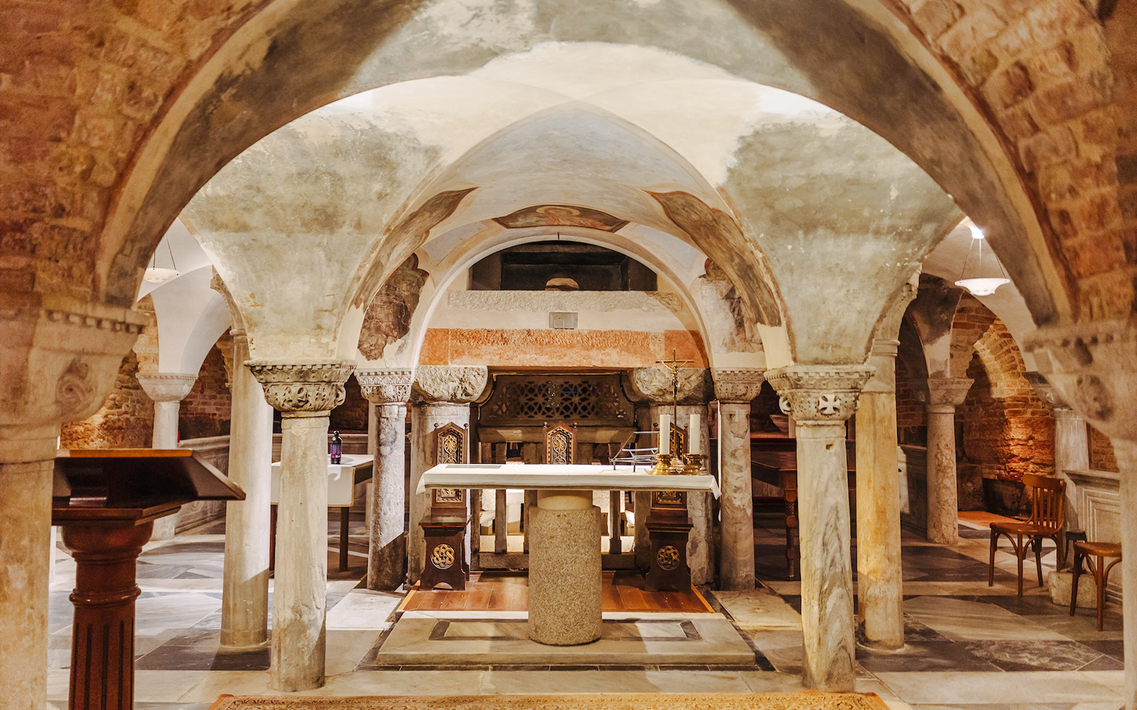 St. Mark's Basilica crypt with ornate columns and altar during exclusive after-hours tour.