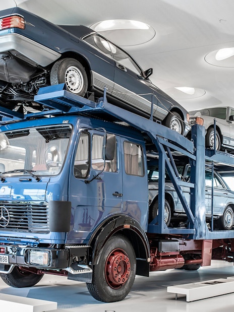 Car transporter exhibit at Mercedes Benz Museum, Stuttgart, showcasing vintage vehicles.