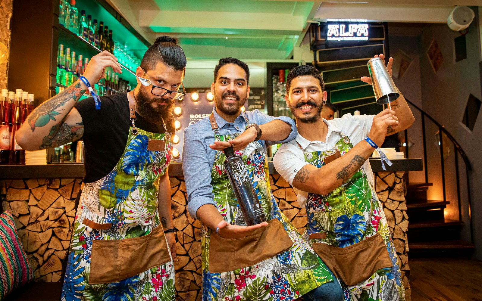 Bartenders at Amsterdam House of Bols cocktail workshop holding shakers and bottles.