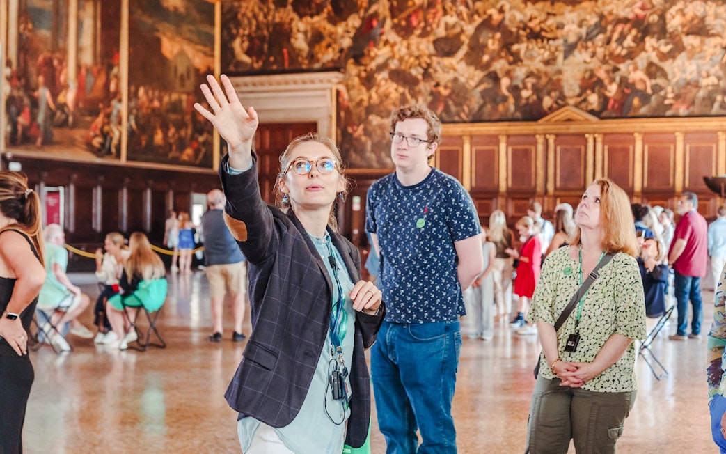 Tour guide explaining artwork during Doge's Palace guided tour in Venice.