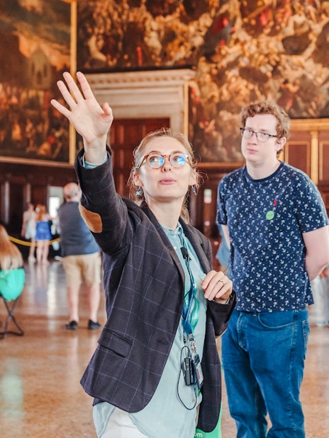 Tour guide explaining artwork during Doge's Palace guided tour in Venice.