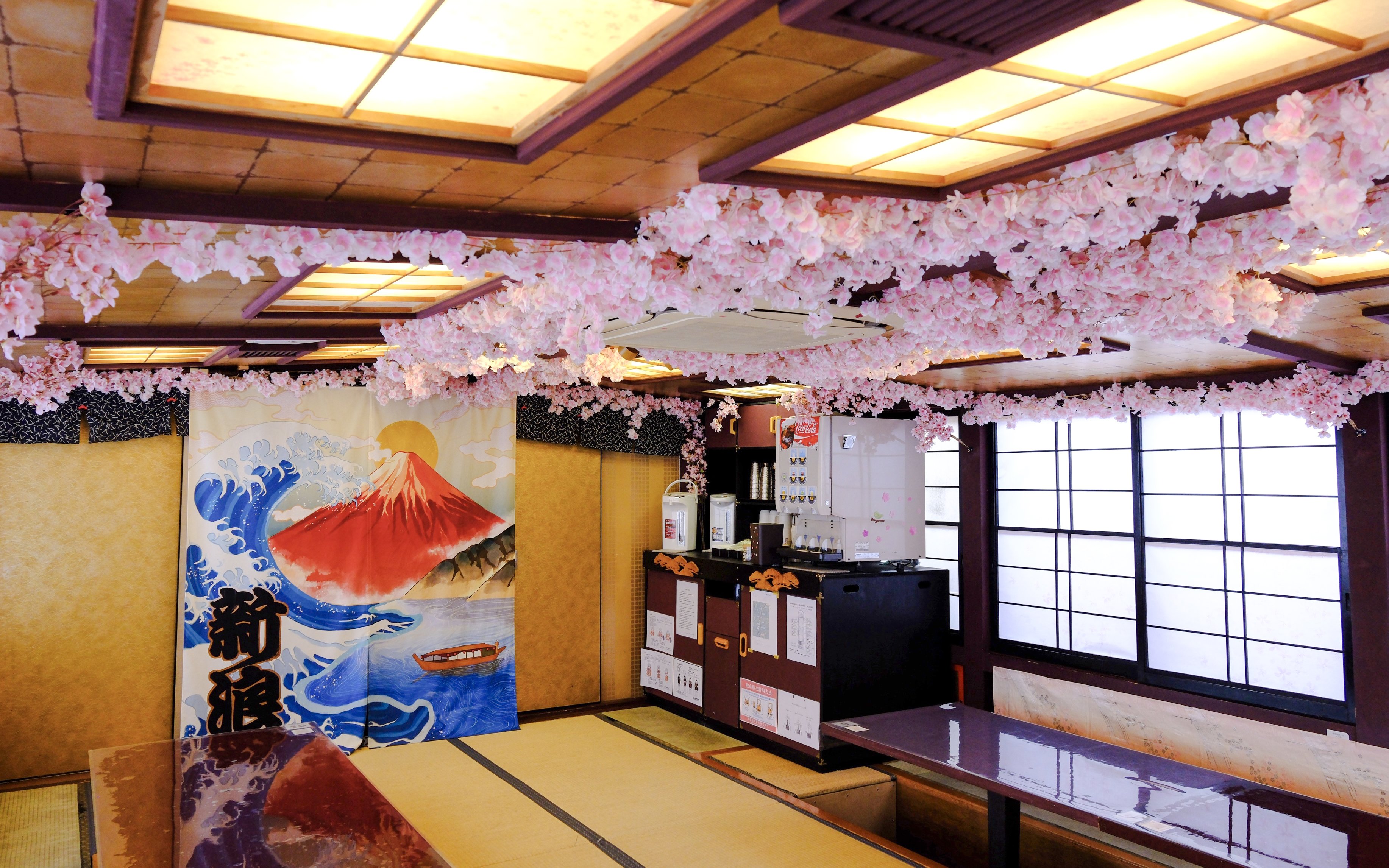 Tokyo tea ceremony room with cherry blossom decor and Mount Fuji artwork.
