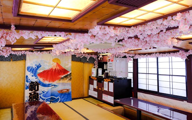 Tokyo tea ceremony room with cherry blossom decor and Mount Fuji artwork.