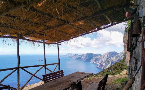 Rustic shelter overlooking Amalfi Coast on Sentiero degli Dei trail.