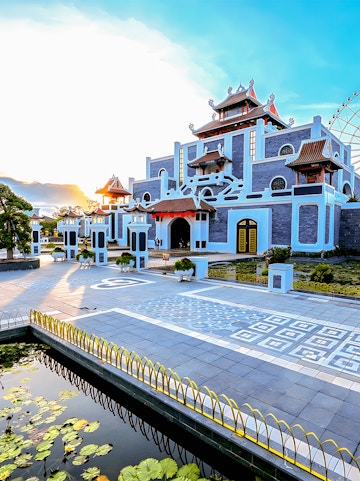 Sun World Asia Park entrance with traditional architecture and ferris wheel in the background.