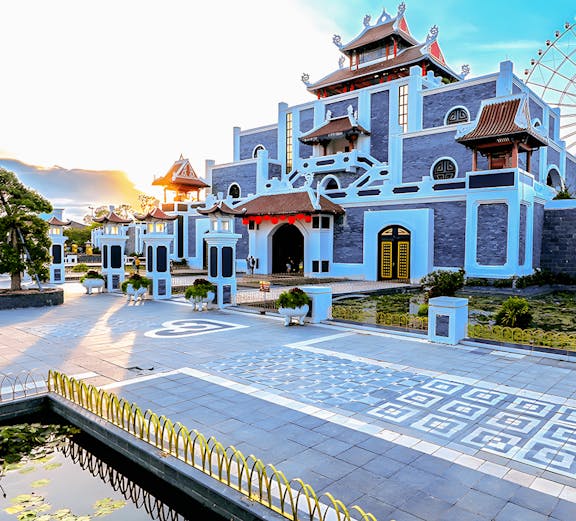 Sun World Asia Park entrance with traditional architecture and ferris wheel in the background.