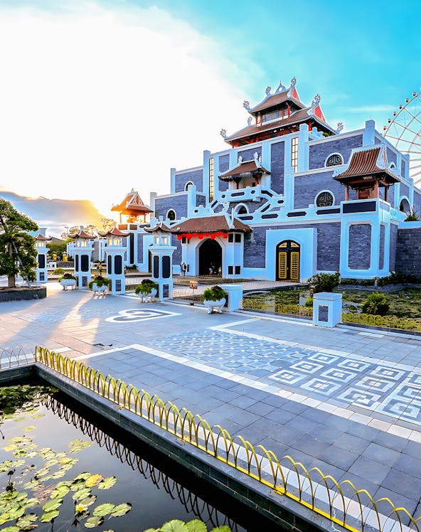 Sun World Asia Park entrance with traditional architecture and ferris wheel in the background.