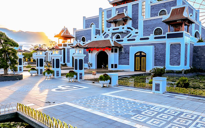 Sun World Asia Park entrance with traditional architecture and ferris wheel in the background.