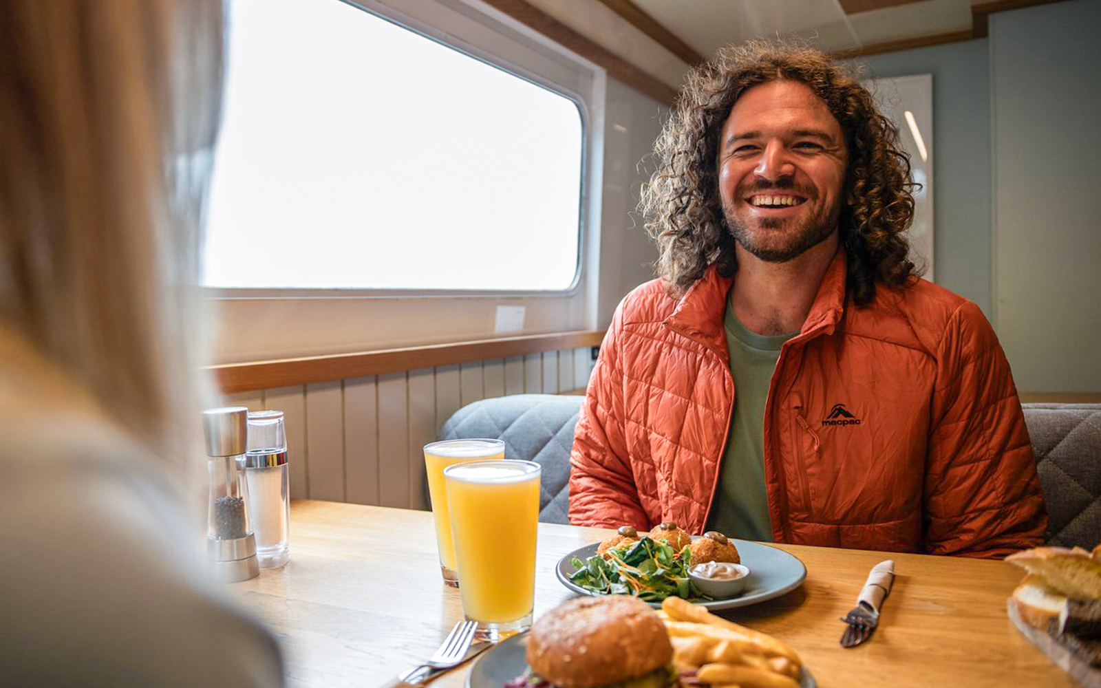 Lunch on Milford Sound cruise with burger, fries, salad, and orange juice.