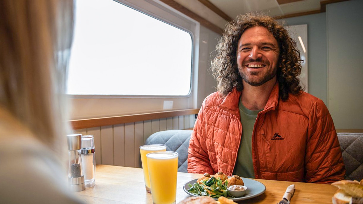 Lunch on Milford Sound cruise with burger, fries, salad, and orange juice.