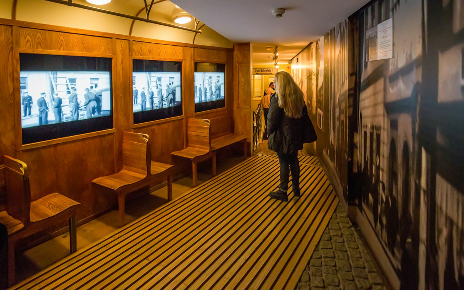 Schindler's Factory Museum interior with visitor viewing historical displays in Krakow.