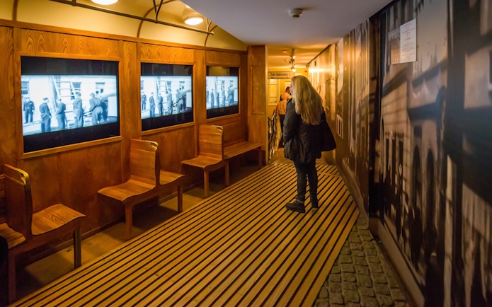 Schindler's Factory Museum interior with visitor viewing historical displays in Krakow.