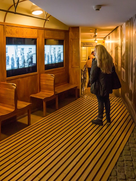 Schindler's Factory Museum interior with visitor viewing historical displays in Krakow.