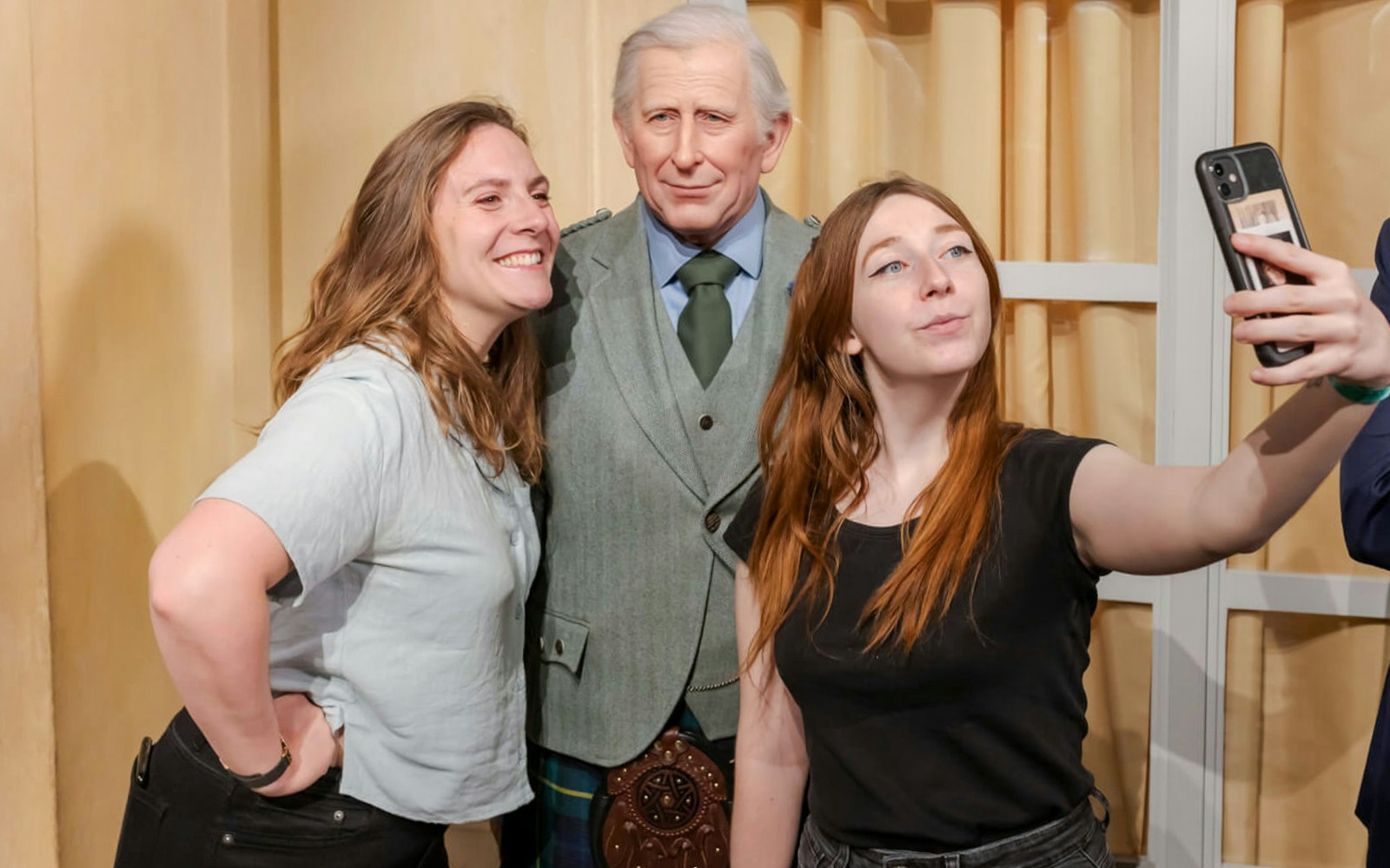 Visitors taking a selfie with a wax figure at Grévin Wax Museum.