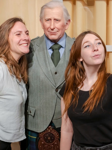 Visitors taking a selfie with a wax figure at Grévin Paris Wax Museum.