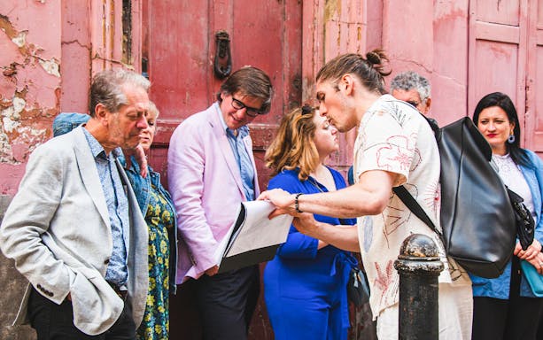 Tour guide explaining to a group on the Brick Lane, Shoreditch & Spitalfields Food Tour in London.
