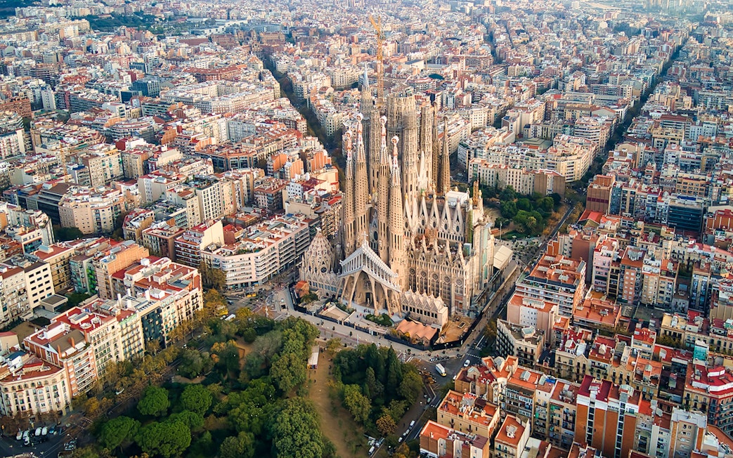Sagrada Familia aerial view in Barcelona, showcasing its intricate architecture amidst the cityscape.