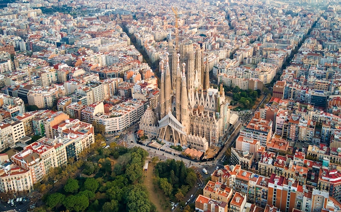 Sagrada Familia aerial view in Barcelona, showcasing its intricate architecture amidst the cityscape.