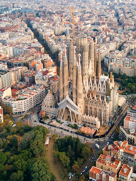 Sagrada Familia aerial view in Barcelona, showcasing its intricate architecture amidst the cityscape.