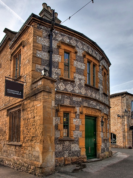 Cotswolds village street with historic stone buildings on a guided day tour from London.