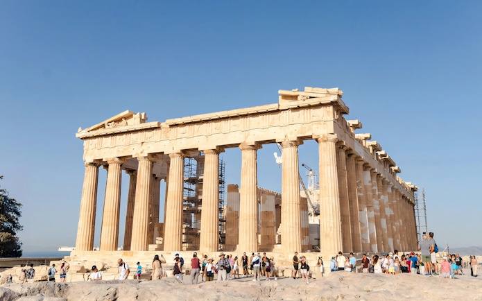 Tourists exploring the Parthenon at the Acropolis in Athens.