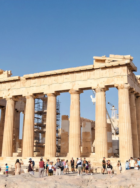 Tourists exploring the Parthenon at the Acropolis in Athens.