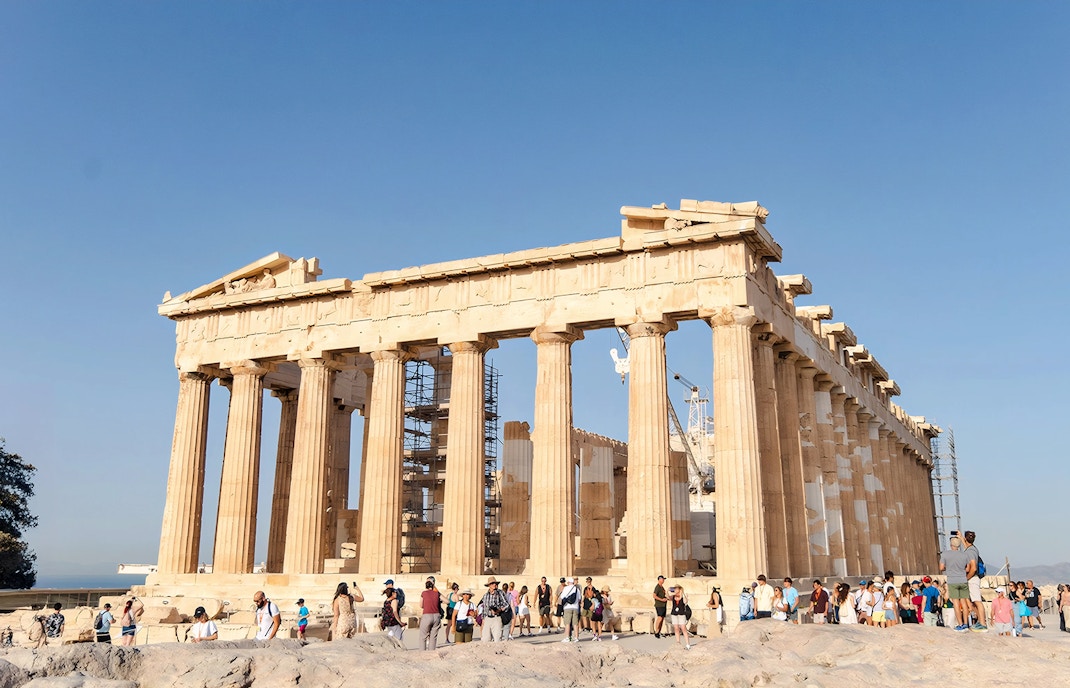Tourists exploring the Parthenon at the Acropolis in Athens.