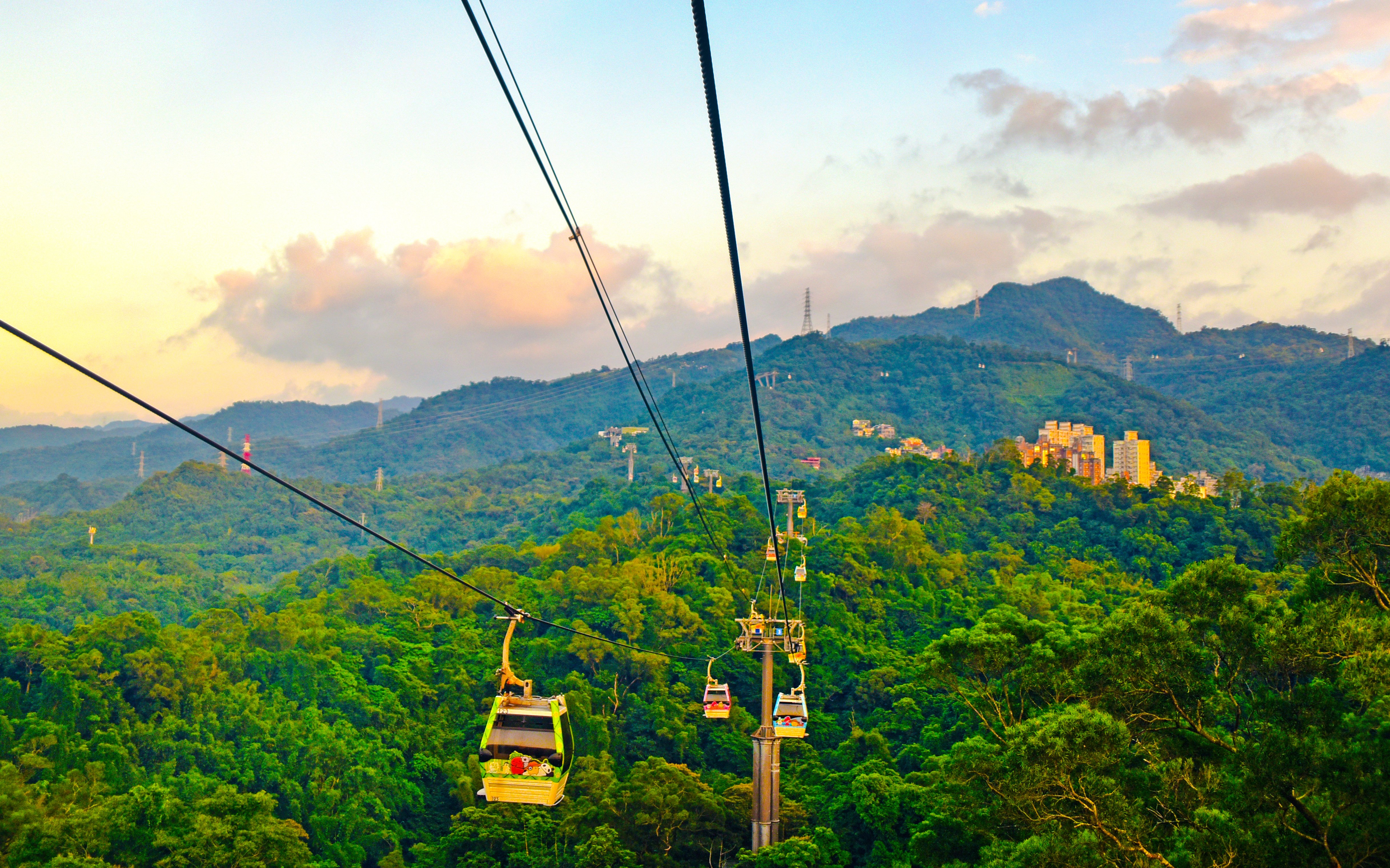 Maokong Gondola over lush hills in Taipei, Taiwan at sunset.