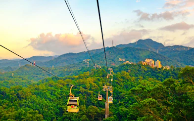 Maokong Gondola over lush hills in Taipei, Taiwan at sunset.