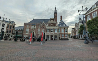 Haarlem city square with historic buildings, part of self-guided exploration game.