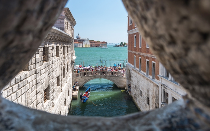 View of Venice canal and bridge from the Bridge of Sighs.