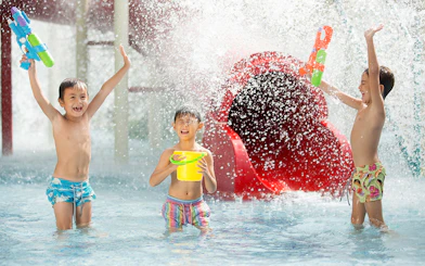 Children playing with water guns at Jungle Splash water park.
