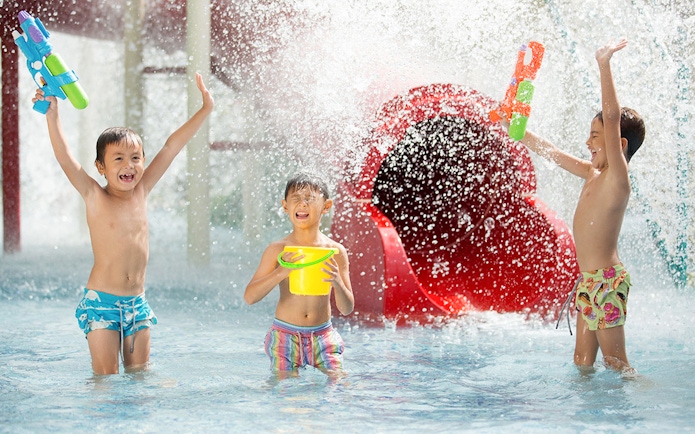 Children playing with water guns at Jungle Splash water park.