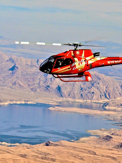 Red Papillon helicopter flying over Lake Mead near the Grand Canyon.