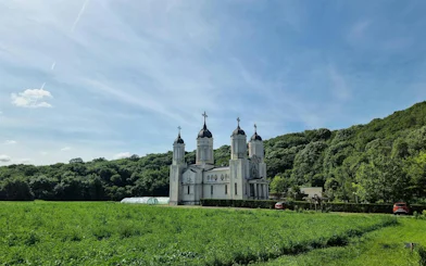 St. Andrew's Monastery surrounded by greenery under a clear sky, Constanta day trip.