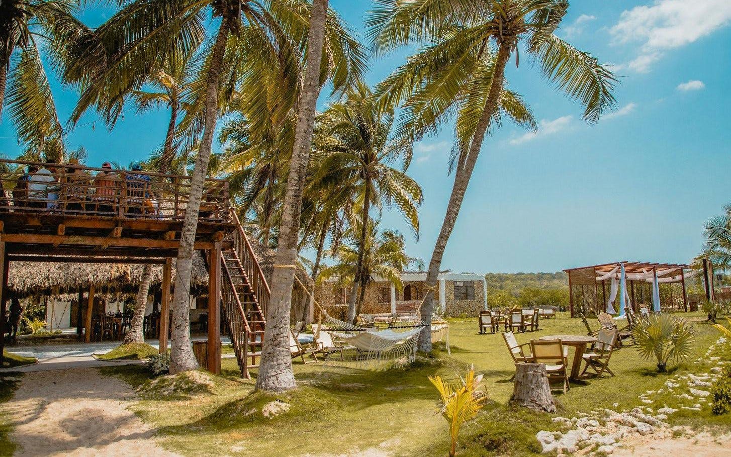 Bungalow-style cabins and outdoor seating at Vista Mare Beach House, Cartagena, Colombia.