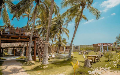 Bungalow-style cabins and outdoor seating at Vista Mare Beach House, Cartagena, Colombia.